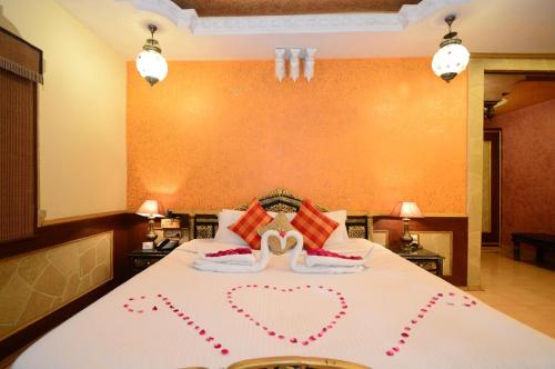 a bedroom with a bed with two hearts on it at CHOKHI DHANI INDORE in Indore