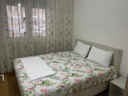 a bedroom with a bed with a laptop on it at Tuse Lux apartments in Skopje