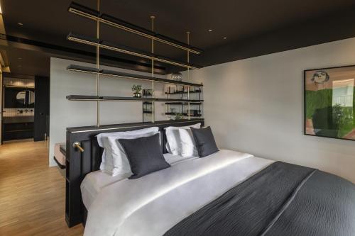 a bedroom with a large bed with white pillows at The Modernist Athens in Athens