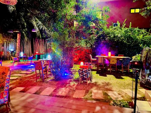 a garden with a table and chairs and lights at Le Patio in Lomé