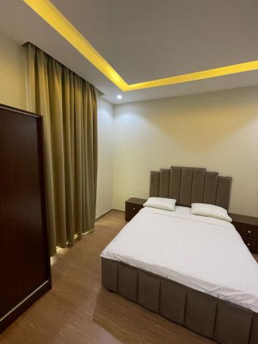 a bedroom with a large bed in a room at Corniche Palace Hotel in Ajman 
