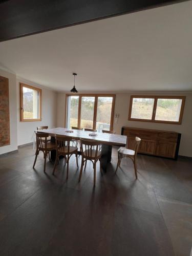 a large dining room with a table and chairs at Hotel le Chalet in Gresse-en-Vercors