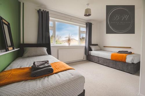 a bedroom with two beds and a window at Popular Contractor 2-Bed House in Lincoln in Lincoln