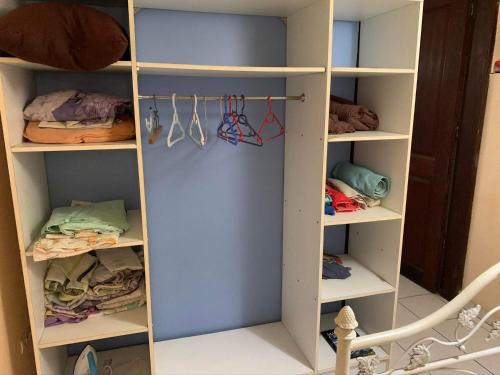 a walk in closet with white shelving at Domaine de Kanelle in Rivière-Pilote