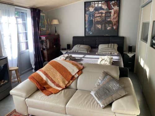 a living room with a couch and a bed at Ken 't Gat Bie&Bie in Maldegem