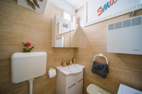 a bathroom with a toilet and a sink at Apartment Sacramento centar Varaždin in Varaždin