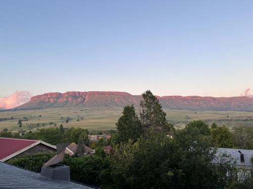 a view of the red mountains from a roof at The Raz in Harrismith