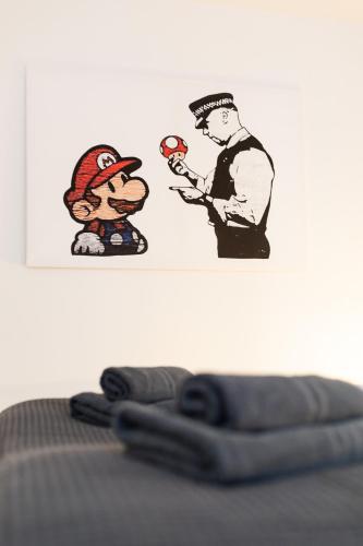 two stickers on a wall with a man holding a gun at Apartments an der Oper - Innenstadt - Zentral - Küche - Wifi - Powered by Ko-Living in Halle an der Saale