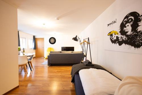 a living room with a bed and a couch at Apartments an der Oper - Innenstadt - Zentral - Küche - Wifi - Powered by Ko-Living in Halle an der Saale