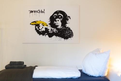 a bedroom with a monkey holding a banana at Apartments an der Oper - Innenstadt - Zentral - Küche - Wifi - Powered by Ko-Living in Halle an der Saale