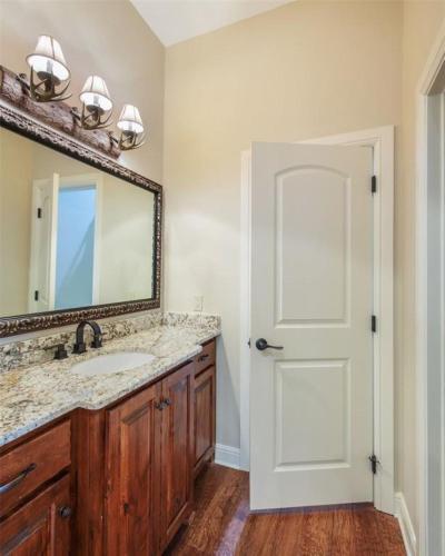 a bathroom with a sink and a mirror at Grapevine Luxury Home in Grapevine