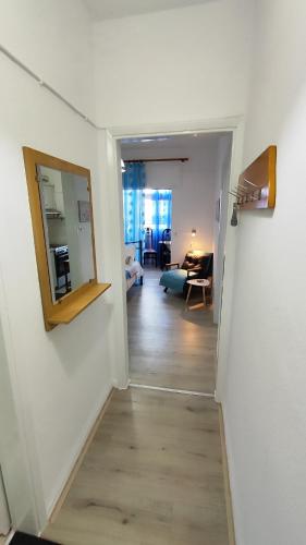 a hallway with a mirror and a living room at Economy apartment in Flogita