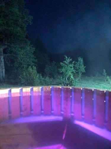 a purple fence in front of a field at night at Refugio entre Montañas - Malalcahuello in Malalcahuello