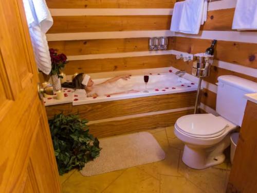 a bathroom with a bath tub with a dog in it at Rustic Cabin in Sevierville