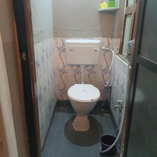 a bathroom with a toilet with graffiti on the walls at Hotel Family Stay Beside Railway Station in Aurangabad