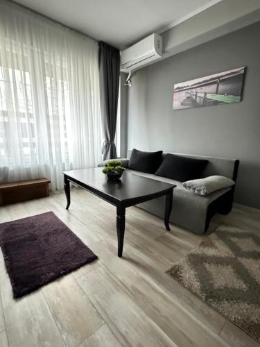 ein Wohnzimmer mit einem Sofa und einem Couchtisch in der Unterkunft Apartment Alex in Sandanski