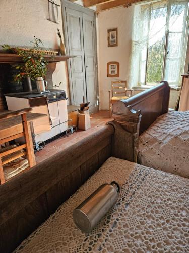 an old bedroom with a bed and a stove at Le Porteau Enchanteur in Sarzay