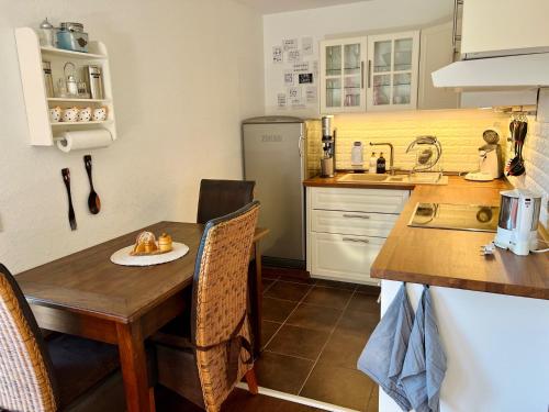 a small kitchen with a wooden table and a sink at Casparidyll in Sigmaringen