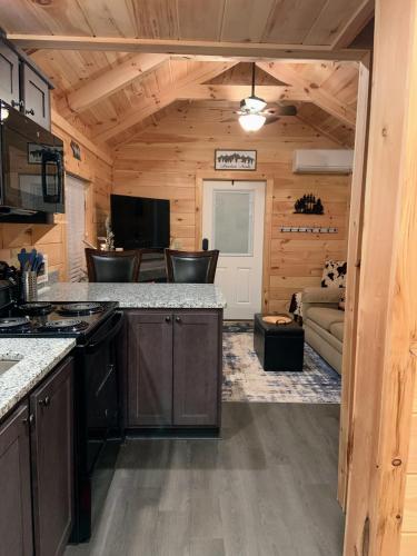 a kitchen and living room in a log cabin at Beaver Dam Mountain Cabins in Travelers Rest
