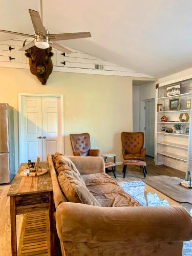 a living room with a couch and a ceiling fan at Beaver Dam Mountain Cabins in Travelers Rest