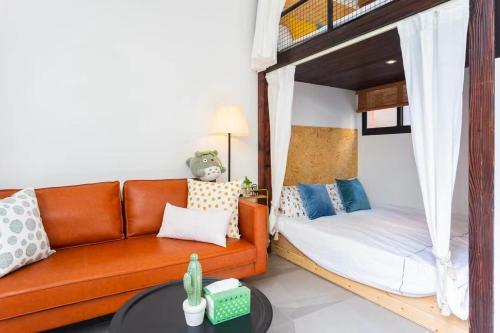 a living room with a couch and a bunk bed at Shanghai Hills&XING 593 Homestay Mid Huaihai Rd Near Metro Line 1 North Zhongshan Rd in Shanghai