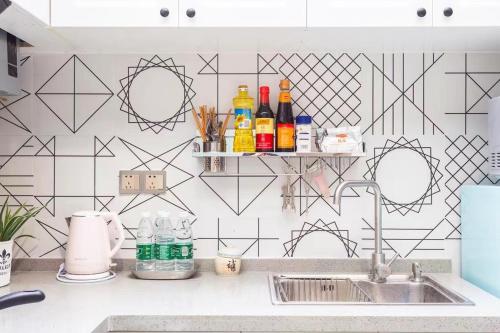 a kitchen with a sink and a wall with geometric tiles at Shanghai Hills&XING 593 Homestay Mid Huaihai Rd Near Metro Line 1 North Zhongshan Rd in Shanghai