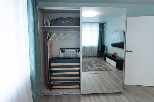a bedroom with a bunk bed and a mirror at Blue Laguun Apartments in Narva