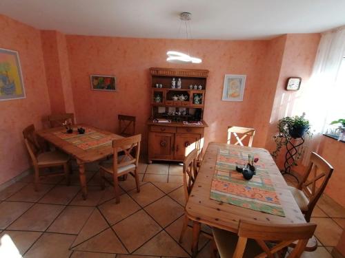 a dining room with two wooden tables and chairs at Gästehaus Burg Molbach in Kreuzau