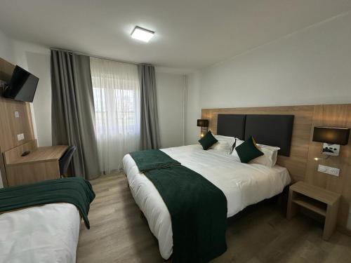 Postel nebo postele na pokoji v ubytování Hôtel NOROTEL