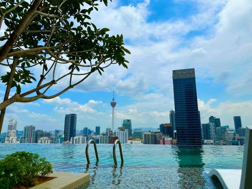 a infinity pool with a view of the city at Axon Suites Infinity Pool in Kuala Lumpur