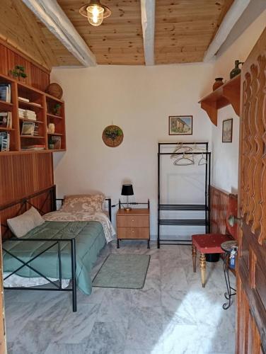 a bedroom with a bed and a table at La Nature in Konístrai