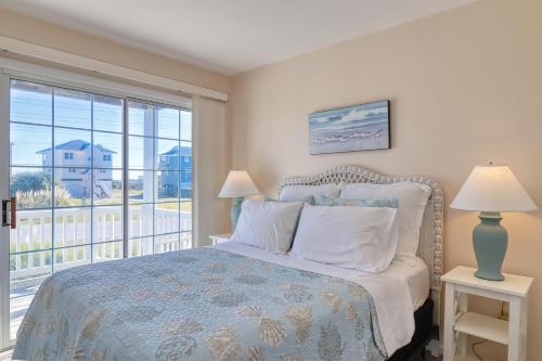 a bedroom with a bed and a large window at Comfort and Sun at Tranquility Cay in North Topsail Beach