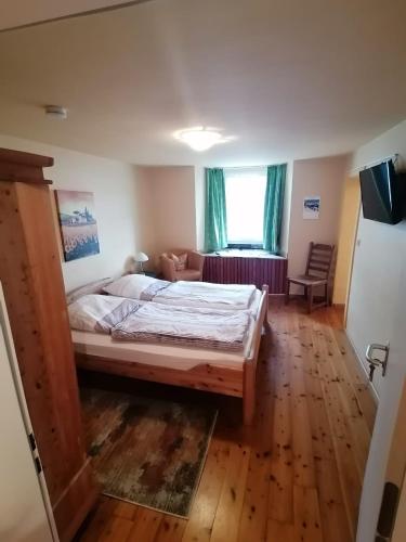 a bedroom with a large bed and a living room at Gästehaus Burg Molbach in Kreuzau