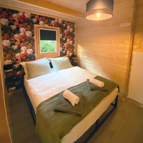 a bedroom with a bed with two towels on it at B&B op de Heuvelrug in Leersum