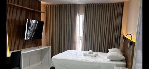 Μια τηλεόραση ή/και κέντρο ψυχαγωγίας στο VISION HOTEL Brasilia Piscina Academia Garagem Flat 12 Andar