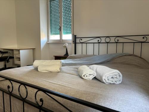 a bed with two towels on top of it at Villa Fiorelli rooms in Rome