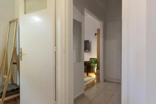 un couloir avec une porte s'ouvrant sur une chambre dans l'établissement Arktinou apartment, à Athènes