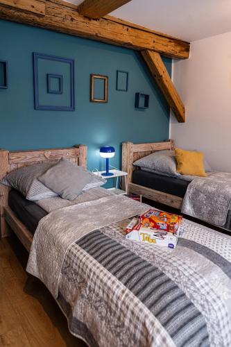 two beds in a room with blue walls at Nasze Calle in Węgorzewo