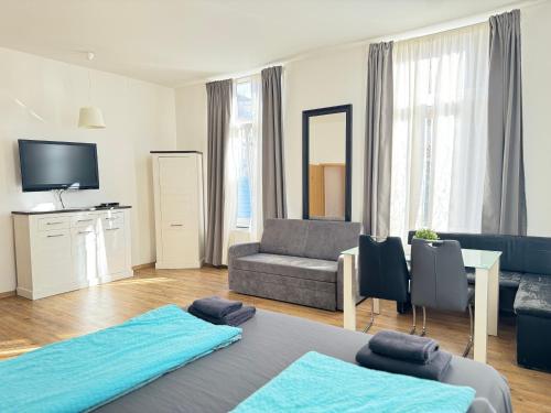 sala de estar con 2 camas y sofá en Pension Dresdener Berge, en Dresden