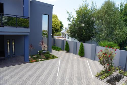 a driveway in front of a blue building at The Raz in Harrismith