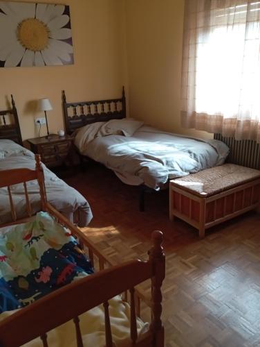a bedroom with two beds and a window at Bons Aires in Llivia