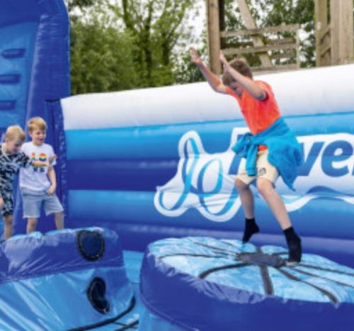 a boy jumping on a inflatable at Haven holiday park Cleethorpes beach in Cleethorpes