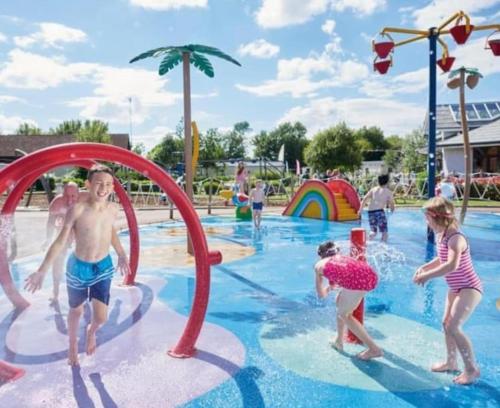 a group of children playing in a pool at a water park at Haven holiday park Cleethorpes beach in Cleethorpes