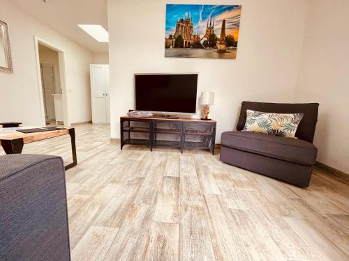 a living room with a flat screen tv and a couch at Ferienwohnungen Mey Haus zum Rosenstock in Erfurt