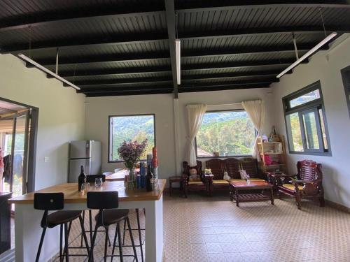 a living room with a table and some chairs at Lam Nguyên Charming House in Bao Loc