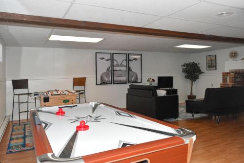 a living room with a pool table in it at Walk To Parks, Dining & Lake! Game Room! Hot Tub! in Watkins Glen