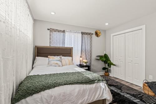 a bedroom with a bed and a window at 2BR-2BA Luxy Dendrobium Oasis, Pet Friendly, Family Friendly, Free Parking & Balcony in Philadelphia