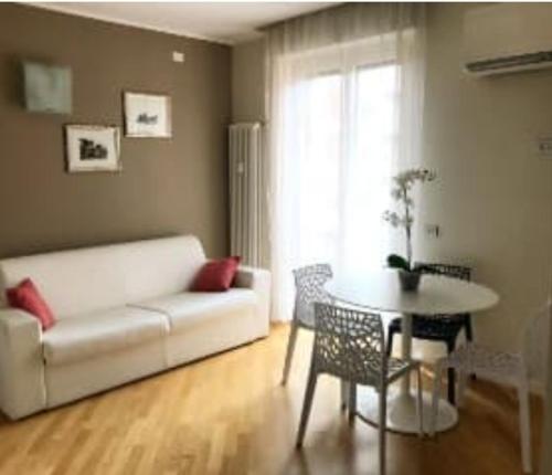 a living room with a white couch and a table at Maison Azzurra in Naples