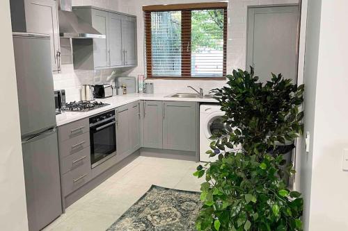 a white kitchen with a sink and a dishwasher at Close to Belfast City Centre.Modern Opened Planned in Belfast