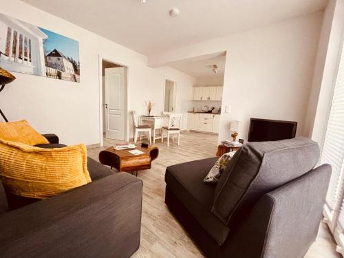 a living room with a couch and a table at Ferienwohnungen Mey Haus zum Rosenstock in Erfurt